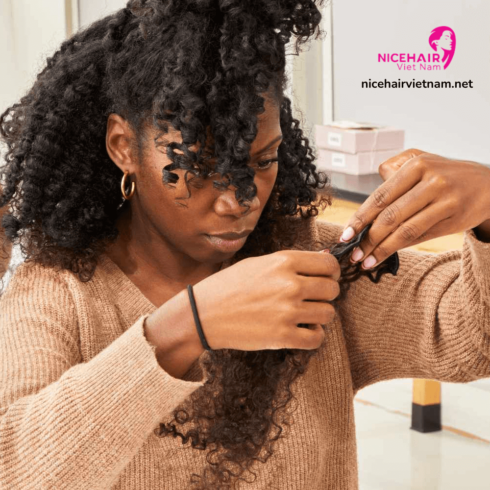 A woman using clip-in hair extensions to add hair volume